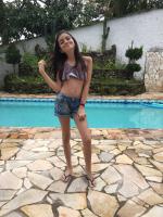 Cute little girl in jean shorts with a flat tummy that loves the camera