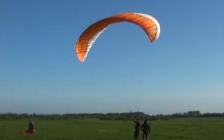 flight of a 12-year-old boy on a motorcycle paraglider.