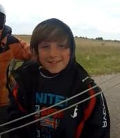 flight of a boy 11 years old on a motorcycle hang glider
