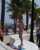 Young topfree beach girl